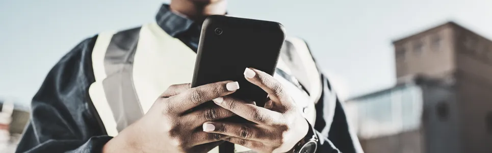 contractor clocking in on their phone while at a job site